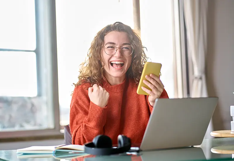girl cheering holding phone