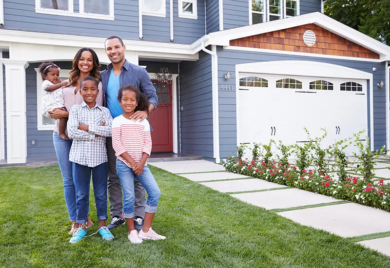 family in front of new home