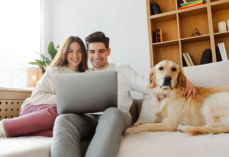 couple on couch with dog